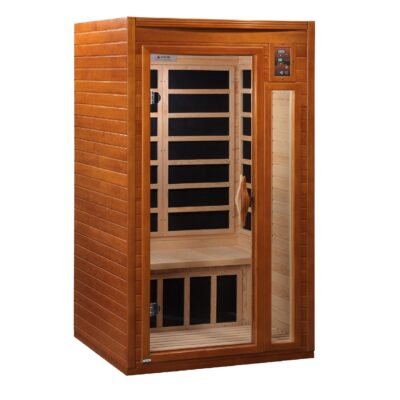 Freestanding infrared sauna placed in a calm residential wellness room with soft lighting, natural textures.