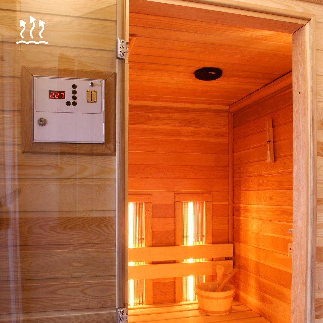 The warm cedar wood interior of a Truregalia home sauna featuring a digital temperature control panel and traditional wooden bucket for an authentic heat therapy experience."